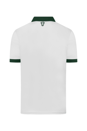 Polo de golf Dogleg Tour femme blanc et vert porté par une golfeuse — golf Suisse